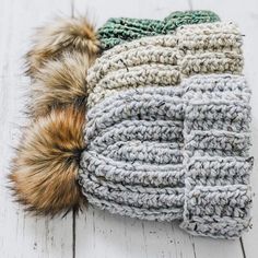 the crochet beanie is made with two different colors and has a fur pom