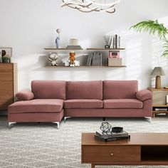 a living room with a pink couch and coffee table