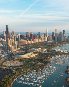 an aerial view of a city with boats in the water and tall buildings on both sides