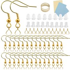 a set of gold colored metal hooks and clips for ear piercings with various sizes