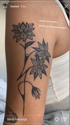 the back of a woman's arm with tattoos on it and an image of a flower