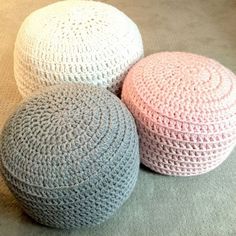 three crocheted poufles sitting on the floor