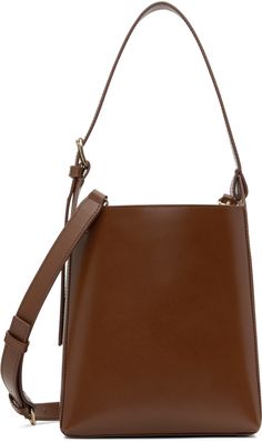 Buffed leather shoulder bag in brown. · Adjustable carry handle · Adjustable and detachable crossbody strap · Logo embossed at side · Patch pocket at interior · Removable drawstring pouch at interior · Full cotton twill lining · H8.25 x W7 x D4.5 Supplier color: Hazelnut Brown Business Bucket Bag With Double Handle, Brown Top Handle Bucket Bag For Business, Brown Double Handle Bucket Bag For Business, Brown Business Bucket Bag With Adjustable Strap, Business Brown Bucket Bag With Adjustable Strap, Brown Bucket Bag With Detachable Handle For Business, Brown Bucket Bag With Detachable Strap For Office, Brown Crossbody Bucket Bag For Business, Brown Bucket Bag With Top Handle And Pouch