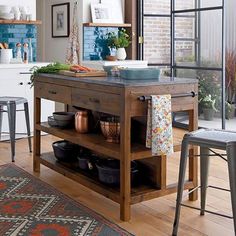 a kitchen island with pots and pans on it