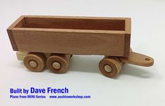 a wooden toy truck with wheels on a white background and the words built by david french below it