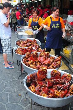 some people are standing around with buckets full of food