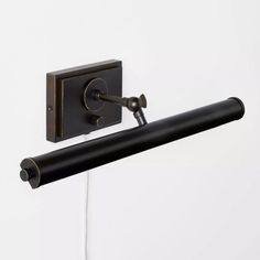 a black wall mounted light with two lights on it