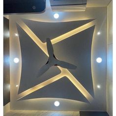 the ceiling is decorated with white lights and an abstract sculpture in the shape of a star