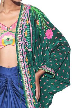 Emerald and pink pure crepe shrug with 3D floral and sequins hand embroidery. Comes with an oriental blue pure satin draped skirt and a blush pink floral printed linen satin blouse. - Aza Fashions Semi-stitched Multicolor Embroidered Shawl With Traditional Drape, Multicolor Floral Embroidered Dupatta Shawl, Bohemian Shawl Dupatta With Printed Border, Bohemian Dupatta With Printed Border Shawl, Blue Shrug, Bohemian Pre-draped Multicolor Block Print Saree, Draped Skirt, Embroidered Skirt, Satin Blouse