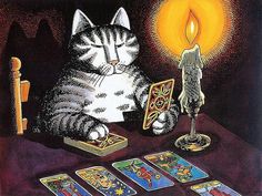 a cat sitting at a table with cards and a candle