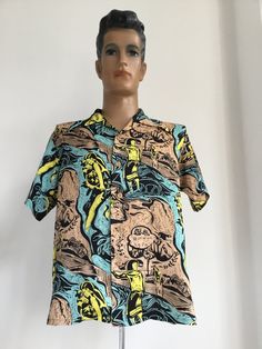 This is a rare print in fabulous colours. Keoni of Hawaii original designed by John Meigs produced by Sun Surf. Amazing Gauguin influenced graphic design print in black background with tan, turquoise and yellow in great condition. Single flat fronted pocket with wooden buttons in 100% Rayon.  Label says M, measurements:  Shoulder to shoulder: 18.5 inches Pit to pit: 22.5 inches Length: 28 inches Sold as seen. No returns. Please contact seller for further info. Multicolor Graphic Print Hawaiian Cotton Shirt, Multicolor Hawaiian Shirt With Graphic Print, Multicolor Cotton Hawaiian Shirt With Graphic Print, Yellow Hawaiian Top With Graphic Print, Retro Patterned Printed Shirt, Retro Multicolor Camp Shirt With All Over Print, Retro Graphic Print Hawaiian Shirt, Retro Hawaiian Shirt With Graphic Print, Retro Yellow Cotton Hawaiian Shirt