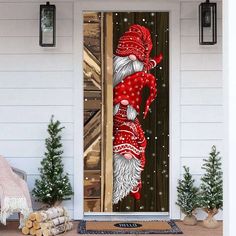 an image of santa claus coming out the front door with christmas decorations on the porch