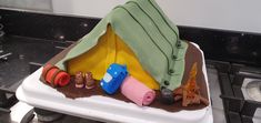 a cake shaped like a camper's tent on top of a stove