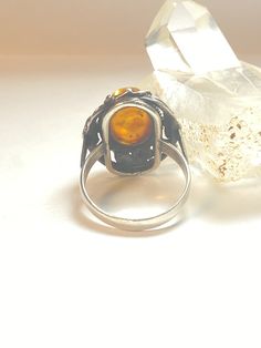 "Amber ring floral sterling silver women Size 8 Weight 5.2g Length 1\" Width. 5/8\" Thinnest part of band 1/8\" Free Shipping & Free Postal Insurance Delivered in a Gift Box If you do not want the ring polished and want to leave the natural patina please let me know at the time of purchase as I do polish rings before I ship rings out. Thanks Free First Class shipping and postal insurance is included. If you want to upgrade to priority kindly pay an additional fee to do so. This is recommende Art Deco Cabochon Ring For Anniversary, Art Deco Cabochon Rings For Weddings, Art Deco Cabochon Wedding Rings, Antique Adjustable Rings For Anniversary, Antique Adjustable Rings With Intricate Design, Vintage Adjustable Sterling Silver Rings, Vintage Oval Flower Ring Hallmarked, Victorian Adjustable Sterling Silver Ring, Vintage Crystal Promise Ring