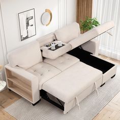 a living room with a sectional couch and coffee table in the middle, on top of a rug