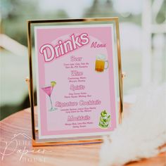 a pink menu sitting on top of a wooden table