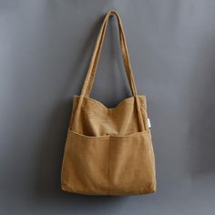 More Colors:  https://www.etsy.com/shop/Bokzim?search_query=double+pocket ------------------------------------------------------- Double Pocket Corduroy Tote Bag 👉 F E A T U R E S - Soft corduroy fabric  - Multi pockets  - 13" laptop fit in  - Magnetic closure - Handmade in Korea  [Large Capacity]: big enough to carry a 13" laptop and an A4 ring binder  [Multi compartments]: TWO exterior pockets and ONE inner pocket help organize your essentials effectively. [Material]: Feel the difference. Soft corduroy fabric is used. No smell of bad chemicals.  📏 D I M E N S I O N S Length: 13.3" (34cm) Height: 14.5" (37cm) Depth: 3.1" (8cm) Drop Length: 12.6" (32cm) Handmade in Korea  . Corduroy Bag, Corduroy Tote Bag, Tan Women, Small Cosmetic Bags, College Bags, Back To School Gift, Diy Tote Bag, Corduroy Fabric, School Gift