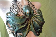 a mannequin wearing an octopus costume with net on it's back and head