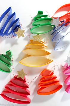 colorful paper christmas tree decorations on a white surface