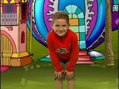 a young boy standing in front of a colorful background