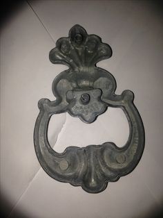 an old metal door handle on a white wall