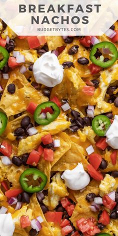 an overhead view of nachos with black beans, cheese and peppers