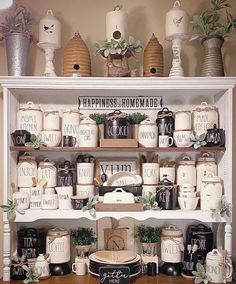 a shelf filled with lots of different types of coffee cups and mugs on top of it