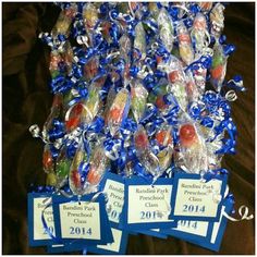 several candy candies are wrapped in cellophane and tied with blue ribbon for sale