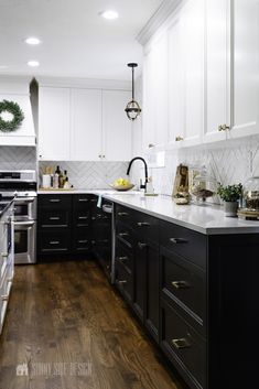 a kitchen with black and white cabinets and wood floors is featured for the sunnyside blog