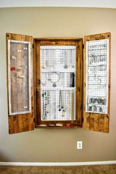 an open window with jewelry hanging on the outside and inside, in front of a beige wall