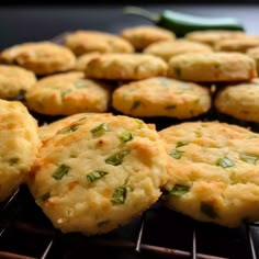 several biscuits are cooling on the grill with green peppers in the backgroung