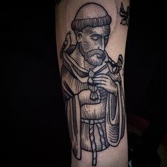 a black and white tattoo of a man with a beard holding a bird on his arm