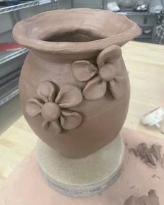 a clay vase sitting on top of a table