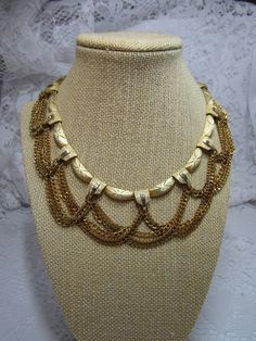 Stunning Kramer gold tone link and looping chain adjustable collar style choker necklace in pristine condition. Gold Bib Necklace Choker, Gold Bib Choker Costume Jewelry, Adjustable Gold Bib Choker Necklace, Gold Choker Bib Necklace As Costume Jewelry, Vintage Adjustable Chain Necklace, Adjustable Gold Curb Chain Necklace, Adjustable Gold Necklace With Curb Chain, Gold Bib Necklace As A Gift, Gold Bib Necklace With Chain For Gift