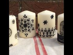 four white candles sitting on top of a table