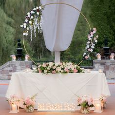 a table with flowers and candles on it