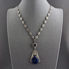 This is an absolutely spectacular Art Deco sterling silver genuine lapis lazuli marcasite daisy chain choker drop pendant necklace from Germany. The silver necklace has an open silver link chain at each end and a decorative nine link marcasite daisy flower chain. In the center is a bail from which a three dimensional panel is suspended that is covered in marcasites, and has a rectangular piece of deep blue lapis. Attached to that is a large sterling pendant with an elongated hexagonal piece of t Antique Sterling Silver Necklace With Jewels, Ornate Sterling Silver Necklace With 17 Jewels, Antique Sterling Silver Jeweled Necklace, Antique Sterling Silver Jeweled Necklaces, Vintage Sterling Silver Necklace With Jewels, Antique Sterling Silver Necklaces With Jewels, Collectible Silver Jewel Necklaces, Fine Jewelry Gemstone Necklace Collectible, Collectible Fine Jewelry Necklaces With Gemstones