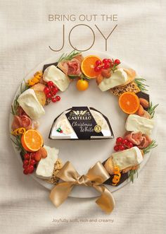 a plate with oranges and other food on it that says, bring out the joy