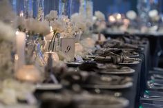 a long table is set with white flowers and candles