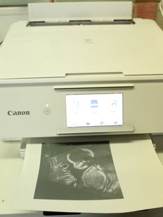 a canon printer sitting on top of a table