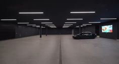 a car is parked in an empty parking garage