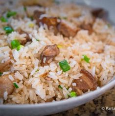 a white bowl filled with rice and mushrooms