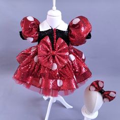 a red minnie mouse dress and hat on display