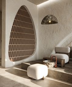 a living room filled with furniture next to a stair case and light hanging from the ceiling