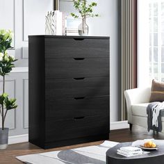 a black chest of drawers in a living room