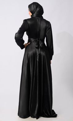 Introducing our exquisite Lycra Satin Flared Abaya, a stunning fusion of elegance and contemporary style. Crafted with meticulous attention to detail, this abaya is designed to elevate your modest fashion wardrobe to new heights. The flared silhouette adds a touch of graceful movement, enhancing the overall allure of the garment. Featuring a front draped pleated style, which adds texture and dimension, creating visual interest and a unique focal point. Complementing the pleats are satin show buttons, delicately embellishing the front of the abaya for a refined finish. For added versatility and cinched-in definition, an attached belt accompanies the abaya, allowing you to adjust the fit according to your preference and accentuate your waistline. The back zipper closure ensures a seamless an Formal Maxi-length Abaya For Fall, Elegant Long Solid Color Maxi Dress, Elegant Long Solid Maxi Dress, Fitted Maxi Length Abaya For Party, Fitted Maxi Length Party Abaya, Fitted Floor-length Party Abaya, Floor-length Fitted Abaya For Party, Party Floor-length Fitted Abaya, Elegant V-neck Wedding Abaya