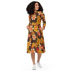 Trip back to the 70s in this tubular floral midi dress! Retro daisy print and funky colors give major hippie flower child vibes. The easy breezy knit fabric with relaxed fit and long sleeves is perfect for spreading peace, love and groovy style! Its soft fabric and flattering cut will ensure you feel comfortable and feminine all day long. Plus, the fitted waist and flared bottom part of the dress will accentuate the wearer's naturally beautiful silhouette. The best part about the dress? It. Has. Pockets.   * 95% polyester, 5% elastane (fabric composition may vary by 1%)  * Fabric weight: 6.19 oz/yd2 (210 g/m2) (weight may vary by 5%)  * Premium knit mid-weight jersey fabric  * Midi length  * Long sleeves  * Side pockets  * Boat neckline  * Fitted on the waist  * Flared bottom part This pro Vintage Multicolor Midi Dress For Fall, Retro Multicolor Midi Length Dress, Multicolor Vintage Midi Dress For Fall, Retro Fitted Multicolor Midi Dress, Fitted Retro Multicolor Midi Dress, Fitted Multicolor Retro Midi Dress, Retro Fitted Midi Dress, Fitted Retro Midi Dress, Vintage Orange Midi Dress For Spring