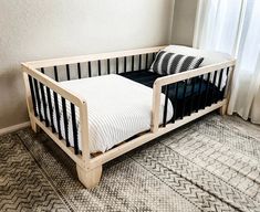 a black and white crib with pillows on it