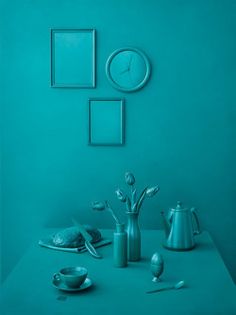 a blue room with teal walls and silver objects