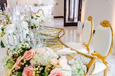 an elaborately decorated table with flowers and vases